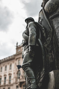 Low angle view of female statue against sky