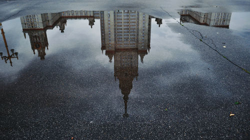 High angle view of reflection of buildings in puddle