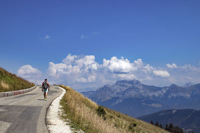 Rear view of man on road against sky