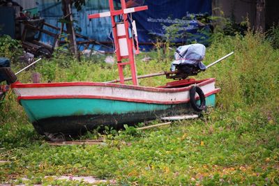 Boats moored on field