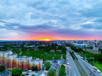 High angle view of road by buildings against sky during sunset