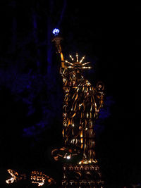 Low angle view of illuminated statue at night