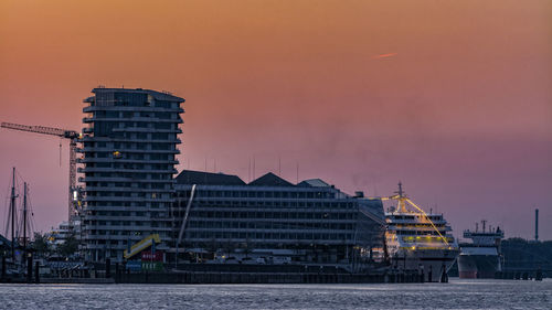 Marco-polo-tower at port of hamburg against orange sky