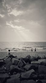 People standing on beach against sky