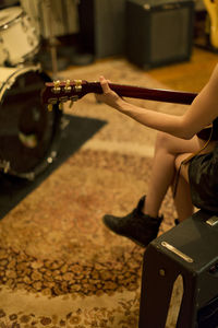 Young woman playing an electric guitar