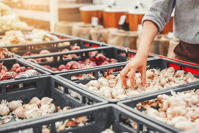 Midsection of person preparing food for sale in market