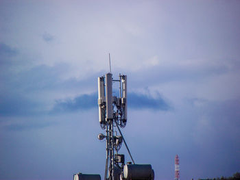 Low angle view of communications tower against sky