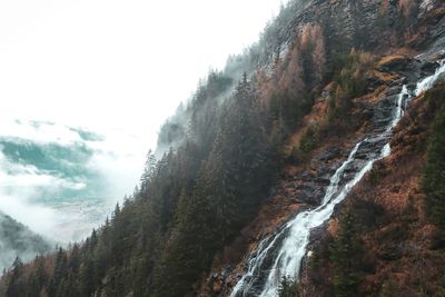 Scenic view of waterfall against sky