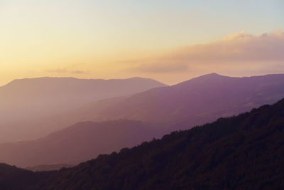 Scenic view of silhouette mountains against sky during sunset