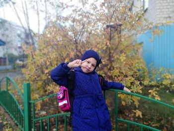 Portrait of girl in warm clothes standing outdoors