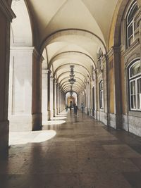 Rear view of people walking in corridor