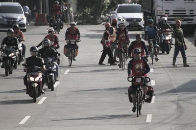 People riding bicycle on city street