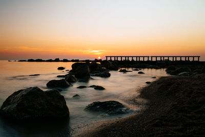 Scenic view of sea against clear sky during sunset