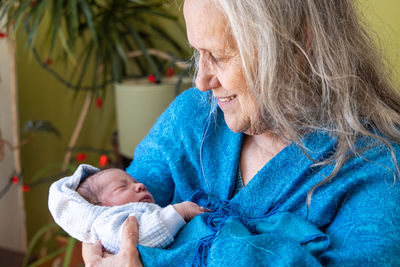 Midsection of grandmother holding granddaughter