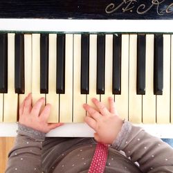 Midsection of baby playing piano