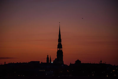 Silhouette of building against sky during sunset