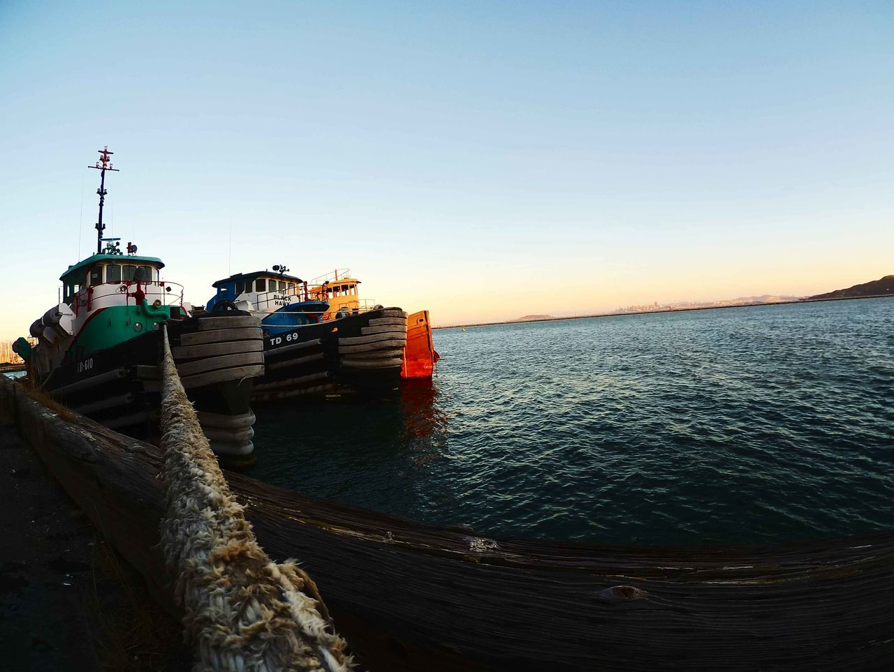 BOATS MOORED IN SEA