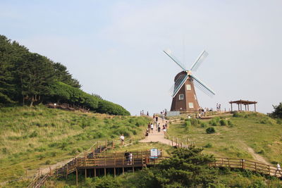 Traditional windmill on field against sky