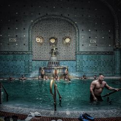 Full length of shirtless man standing in building