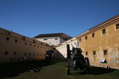 View of residential buildings against clear blue sky