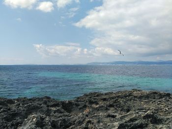 Scenic view of sea against cloudy sky