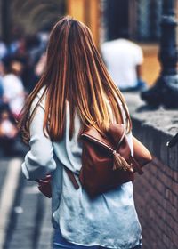 Rear view of woman walking on street