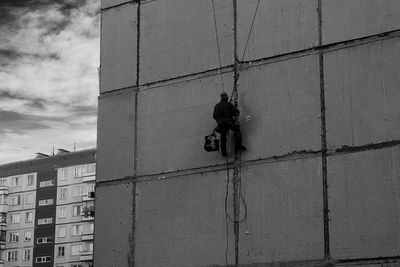 Window washer working on building