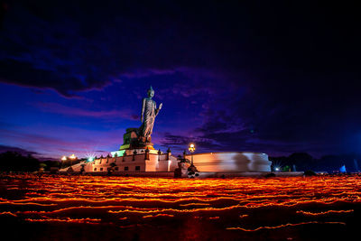 Statue of illuminated building against sky at night