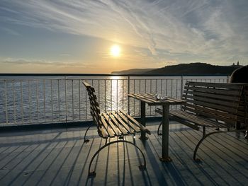 Pier over sea against sky during sunset