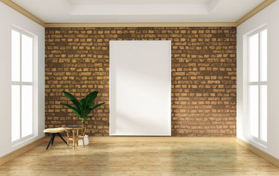 Potted plant on tiled floor against wall