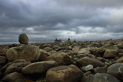 Rocks in sea against sky