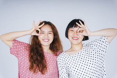 Portrait of lesbian couple against gray background