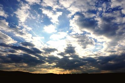 Scenic view of silhouette landscape against sky at sunset