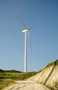 Low angle view of wind turbine against clear sky