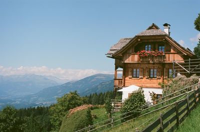 Panoramic view of building and mountains against clear sky