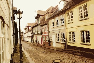 Train on street by buildings against sky