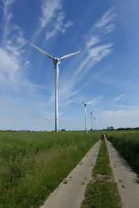 Windmill on field against sky