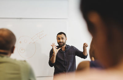 Student explaining classmates at language class