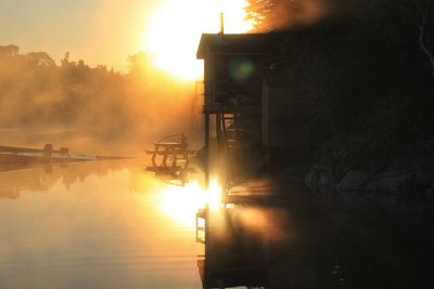 Silhouette buildings against sky during sunset
