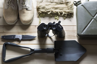 High angle view of hiking equipment arranged on wooden table