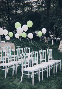 Empty chairs and table in park