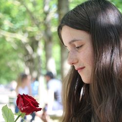 Portrait of woman with red flower