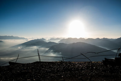 Scenic view of silhouette mountains against sky during sunset