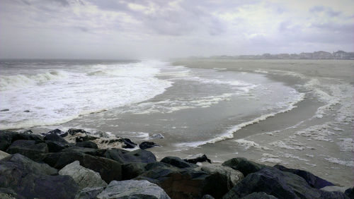 Scenic view of sea against cloudy sky