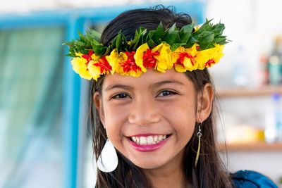 Portrait of happy girl wearing flower