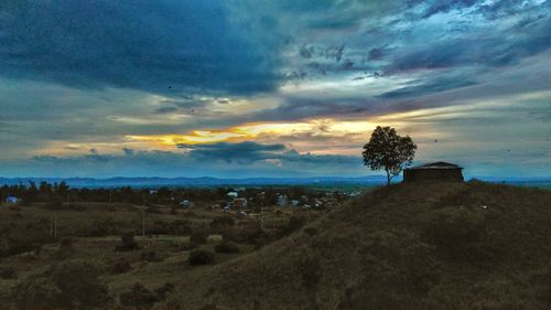 Scenic view of landscape against cloudy sky