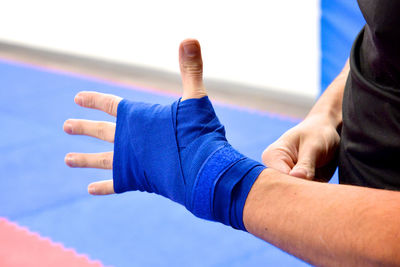 Midsection of athlete wearing with blue bandage