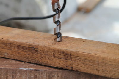 Close-up of drill on wood