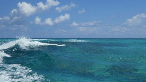 Scenic view of turquoise sea against blue sky