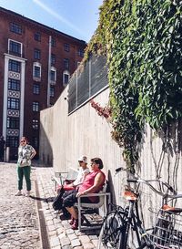 People sitting outside building